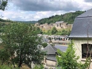 a view of a town with a castle in the background at La Relique ( woning voor 4 tot 6 personen ) in Bouillon