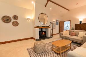 a living room with a couch and a fireplace at Finest Retreats - The Old Parlour in Radstock