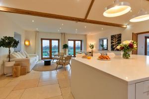 a kitchen and living room with a couch and a table at Finest Retreats - The Old Parlour in Radstock