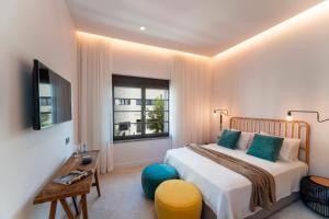 a bedroom with a bed and a window at Naillac Elite Suites in Rhodes Town