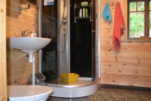 a bathroom with a shower and a sink and a toilet at Kivi-Roosi Holiday House in Lümanda