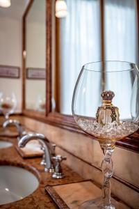 a wine glass sitting on top of a bathroom counter at YiD Leopolda apt few minutes from Central Station in Florence