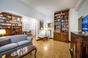 a living room with a couch and a dining room at YiD Leopolda apt few minutes from Central Station in Florence
