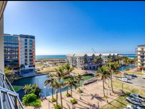 a view of the ocean from the balcony of a resort at The Sails Apartment in Durban