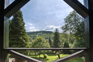 una ventana con vistas a la montaña desde una cabaña en Brenna Leśnica, en Brenna