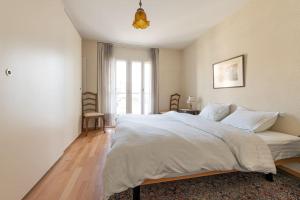 Ένα ή περισσότερα κρεβάτια σε δωμάτιο στο Lakeside-Apartment-1 Grand appartement familial avec 2 terrasses et vue panoramique