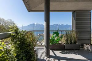 a patio with plants and a view of the water at Lakeside Apartment - Grand appartement familial avec terrasses et vue panoramique in Vevey