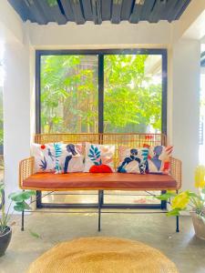 a bench with pillows in front of a window at Balai Lawaan Cozy Homestay in Iloilo City