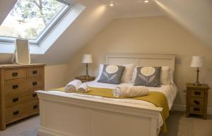 a bedroom with a bed and a window at Bridge Cottage in Luib