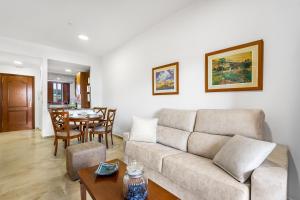a living room with a couch and a table at Don Juan Beach Resort in Estepona