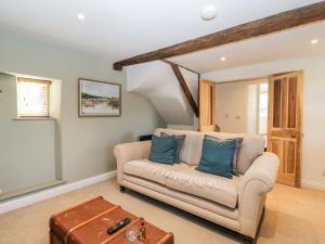 a living room with a couch and a table at The Lantern in Cheltenham