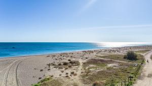 an empty beach with the ocean in the background at Don Juan Beach Resort in Estepona