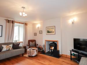 a living room with a couch and a fire place at Learig in Buckie