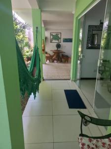 a hallway with a hammock in a house at Pousada Char in Ubatuba