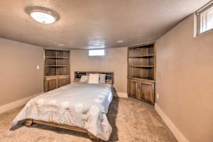 a bedroom with a bed in a room with shelves at Colorado Springs Home Game Room, 3 Mi to Downtown in Colorado Springs