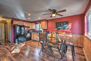 a kitchen with a table and a ceiling fan at Divide Cabin in the Heart of Colorful Colorado! in Midland