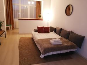 a living room with a couch with pillows on it at Nya Apartment in Sighişoara