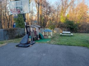a playground with a basketball hoop in a yard at Private Duplex Near BWI/Easy Access to I95 in Linthicum Heights