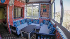 una camera con divano, tavolo e finestre di Complexe rueda a Ouslaf