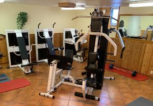 a gym with several exercise equipment in a room at Sjönära boende med tennis- och fotbollsplan in Flen