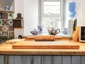 a kitchen with two wooden cutting boards on a counter at Wonderland Cottage in Cupar