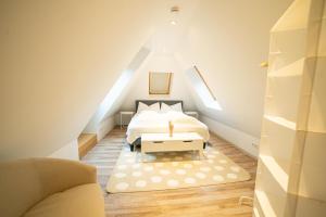 a attic bedroom with a bed and a couch at FULL HOUSE Premium Apartments VN4 in Jena