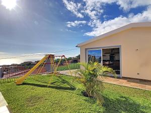 a playground in a yard with a swing at Casa Del Sol by LovelyStay in Relógio do Poiso