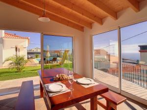 a dining room with a table and a view of the ocean at Casa Del Sol by LovelyStay in Relógio do Poiso