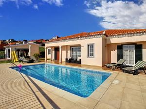 a swimming pool in the backyard of a house at Casa Del Sol by LovelyStay in Relógio do Poiso