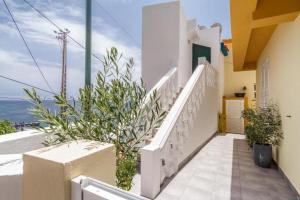 a staircase leading to a house with a view of the ocean at MAKTUB SUNSET COTTAGE A in Paul do Mar