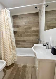 a bathroom with a sink and a toilet and a tub at Cozy & sunny studio in Saavedra in Buenos Aires