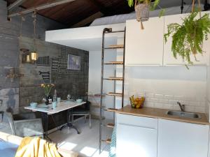 cocina con mesa y fregadero en una habitación en Mooi appartement in Werkplaats, en Kampen