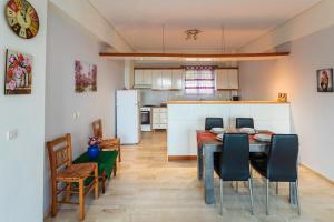 a kitchen and dining room with a table and chairs at Koroni Seaview Retreats - Summer Escape Lodgings in Koroni