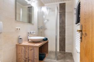 a bathroom with a sink and a shower at Landhaus Kendler in Saalbach Hinterglemm
