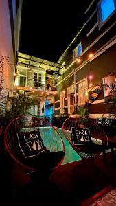 two chairs sitting on a table in front of a building at Casa Tuxi in Rio de Janeiro