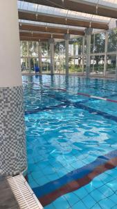 a swimming pool with blue water in a building at יולי גולף in Caesarea