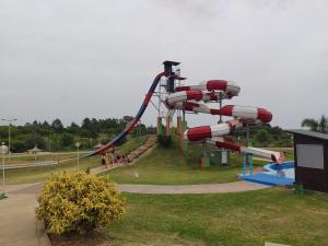 a roller coaster in a park with people on it at Cabaña Don Oscar in Federación