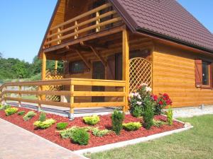 un giardino di fronte a una cabina con fiori di Oaza Spokoju - Domki a Polanica-Zdrój