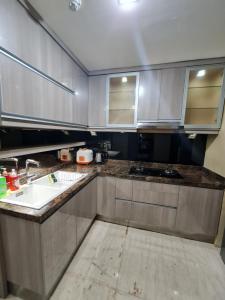 a kitchen with stainless steel cabinets and a sink at St. Moritz Apartement Royal 2br in Jakarta