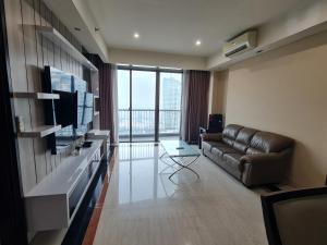 a living room with a couch and a television at St. Moritz Apartement Royal 2br in Jakarta