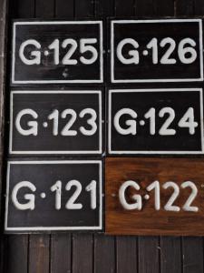 a group of signs with numbers on a wooden wall at Apartma GABER 125 - Rogla in Zreče