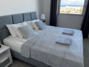 A bed or beds in a room at Ocean Garden Sunset Apartment - heated swimming pool Free WIFI