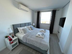 A bed or beds in a room at Ocean Garden Sunset Apartment - heated swimming pool Free WIFI