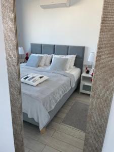 A bed or beds in a room at Ocean Garden Sunset Apartment - heated swimming pool Free WIFI