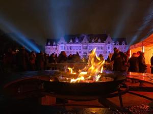 a fire pit in front of a building with lights at La Loge en Or - Parking public - Triplex - Proche centre et autoroute in Lens