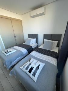 A bed or beds in a room at Ocean Garden Sunset Apartment - heated swimming pool Free WIFI