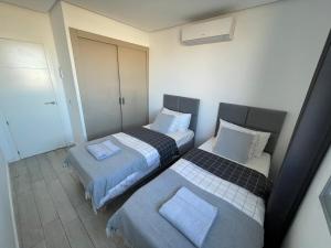 A bed or beds in a room at Ocean Garden Sunset Apartment - heated swimming pool Free WIFI