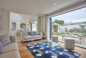 a living room with a couch and a table at 5 The Sands in Polzeath