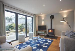 a living room with a living room with a fireplace at 5 The Sands in Polzeath