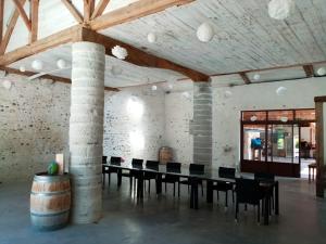 a large room with a table and chairs and a barrel at Villa de 7 chambres avec piscine privee jardin amenage et wifi a Saint Jean de Marsacq in Saint-Jean-de-Marsacq